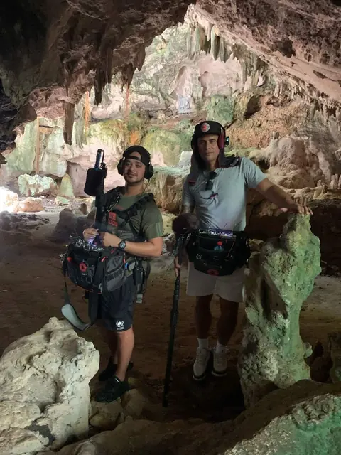 Johnathan Lopez and a boom operator in a cave location