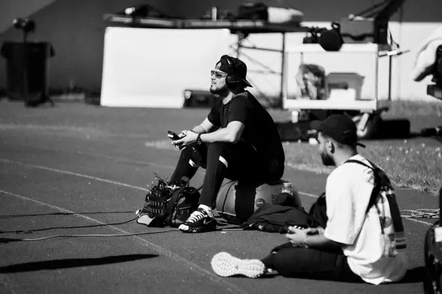 Johnathan Lopez monitoring sound trackside on a sports shoot