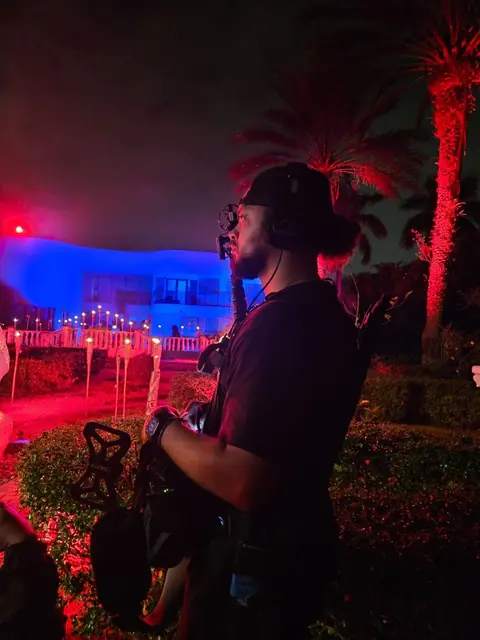 Johnathan Lopez booming a night exterior at a Miami waterfront mansion