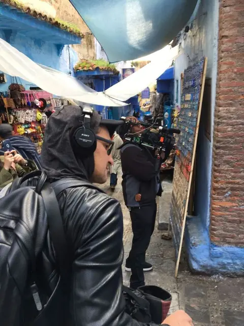Lemuel Ruiz recording in a crowded street market